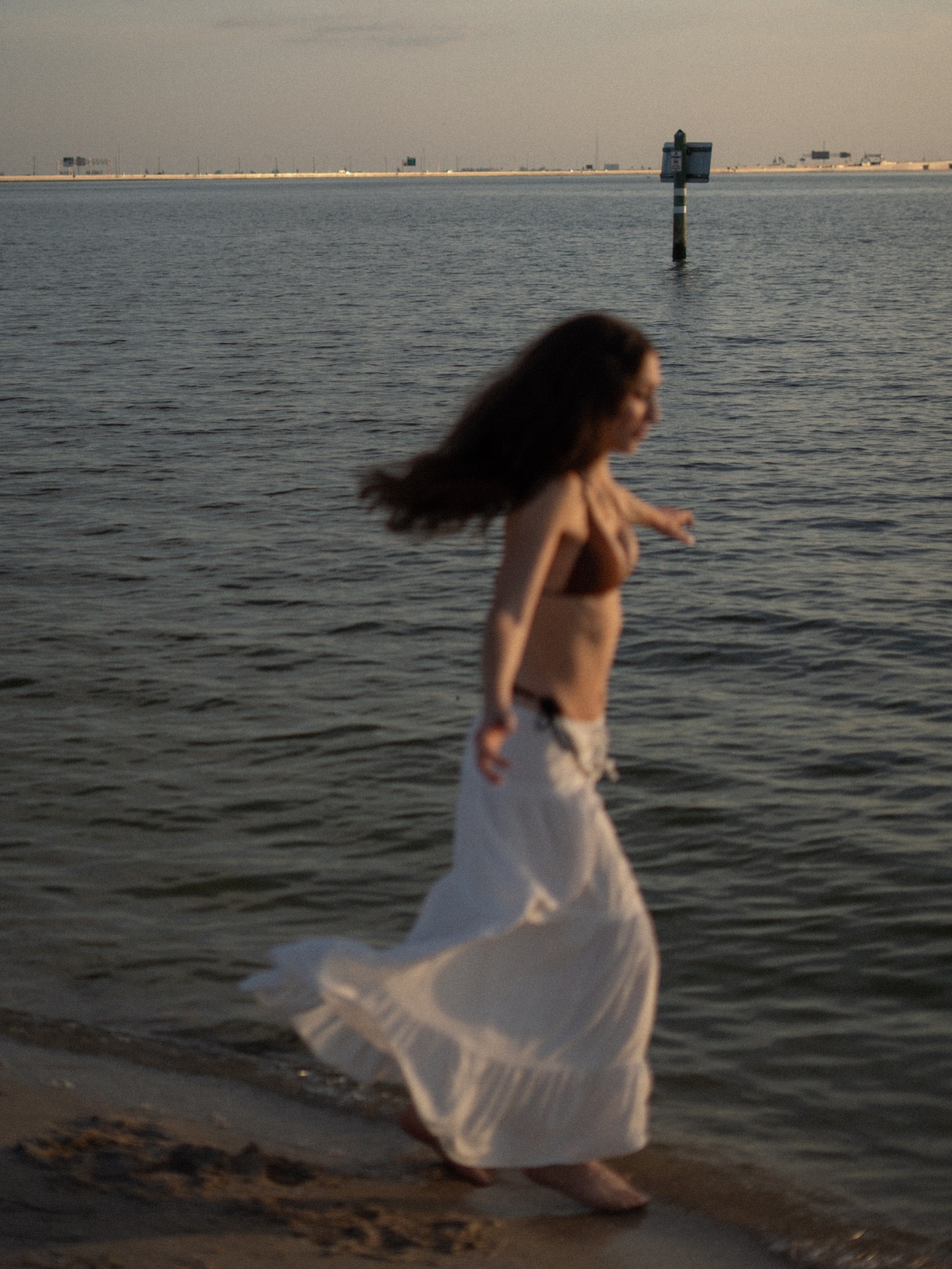 Lindy turning on the shoreline with her skirt in motion