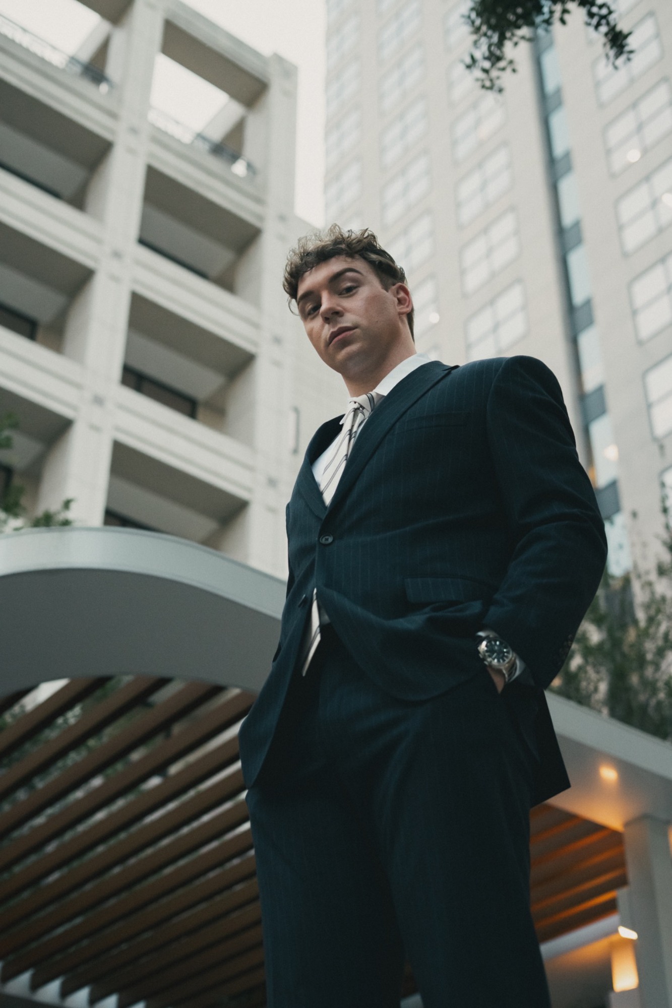 An editorial city portrait in a dark suit