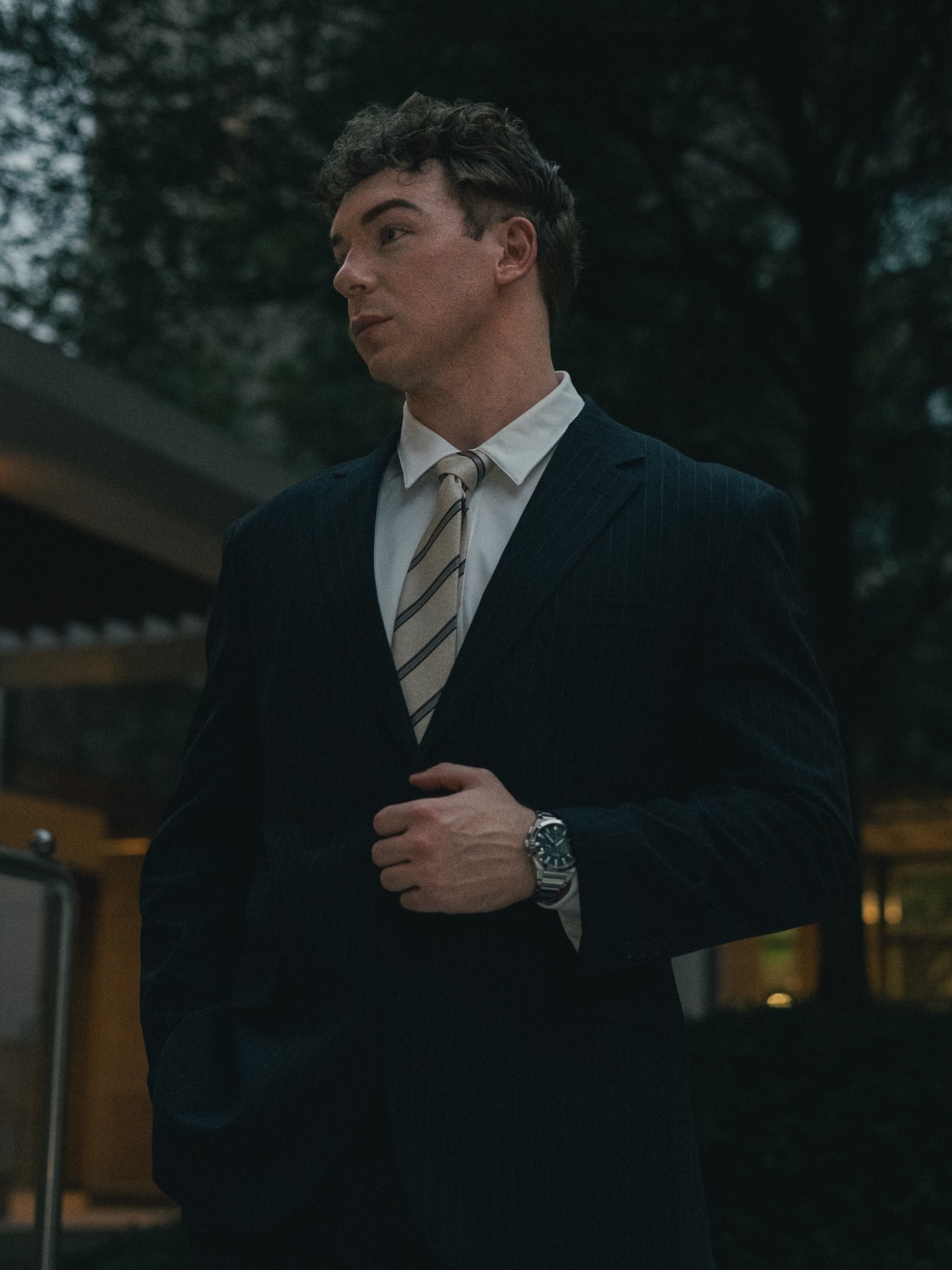 A thoughtful portrait with modern architecture and greenery
