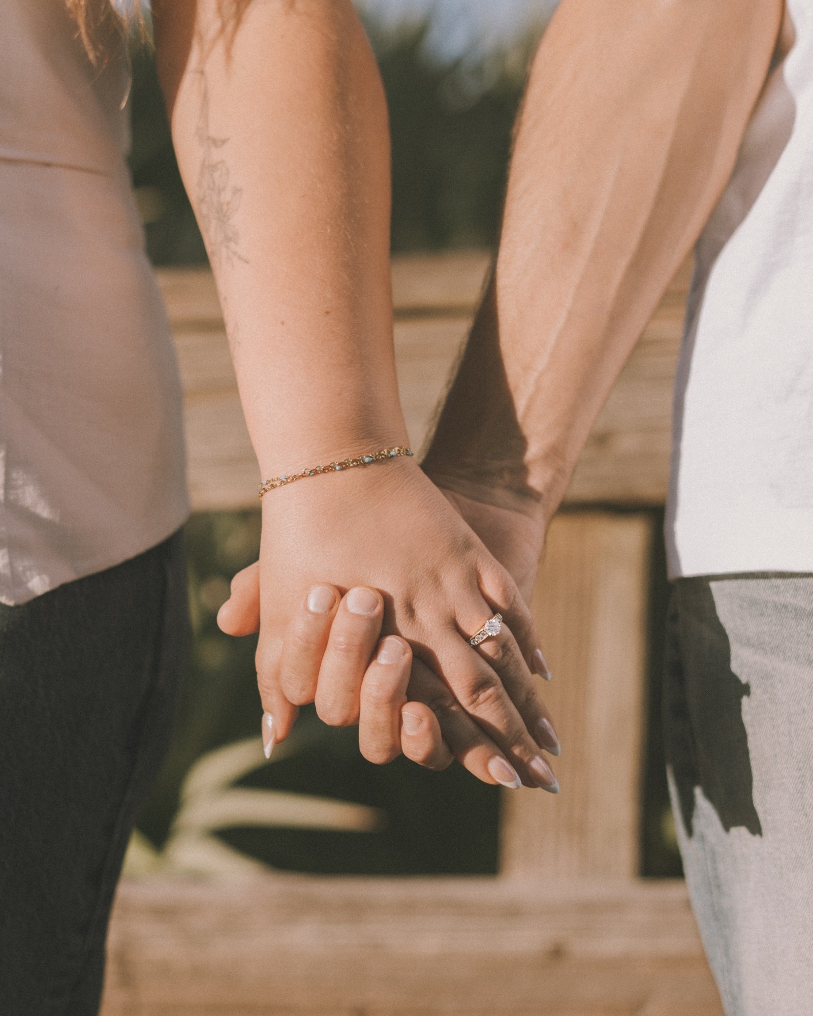 Hands joined together with an engagement ring